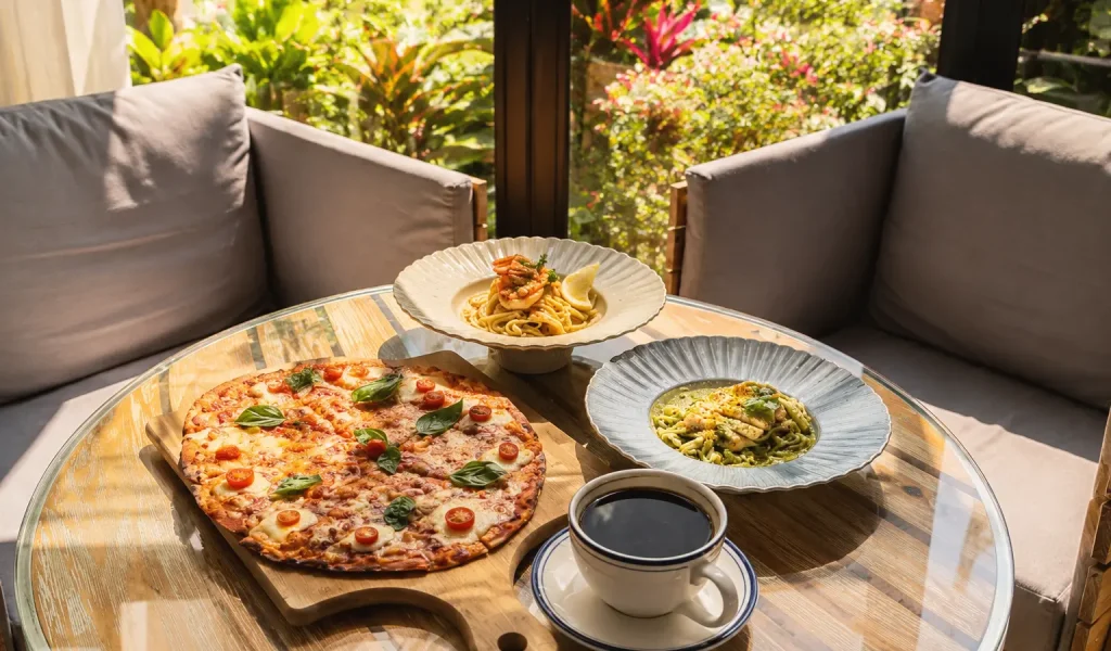 Cozy table spread with pizza, pasta, and coffee at Wondellea Cafe & Resort, a relaxing cafe in Cavite.